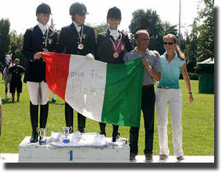 Italian podium, "Good Luck Piero Sangiorgi" written on the flag. The pony team trainer is riding at the Olympics.