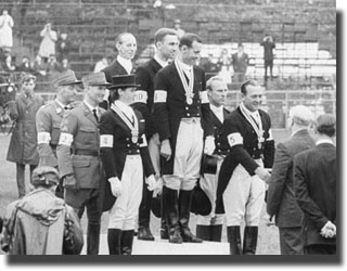 Tokyo 1964, Games of the XVIII Olympiad. Team dressage: on the podium (L to R) the teams from Switzerland (2nd with 2526.0 pts), the Federal Republic of Germany (1st with 2558.0 pts) and the Soviet Union (3rd with 2311.0 pts). Reiner KLIMKE is surrounded by compatriots Josef NECKERMANN and Harry BOLDT.